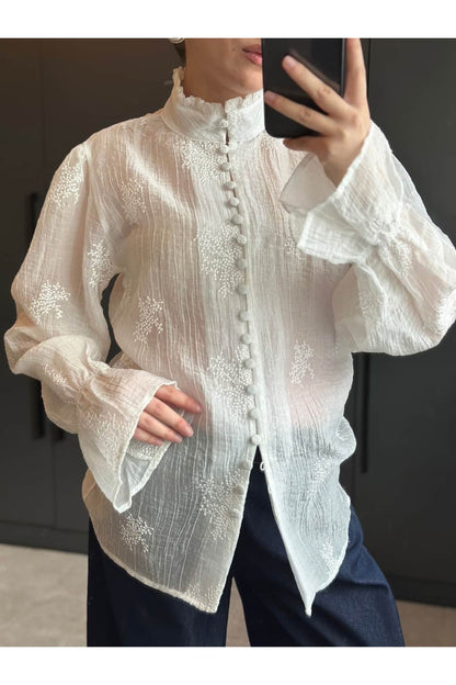 Long-sleeved embroidered shirt with ruffles and elasticated cuffs.