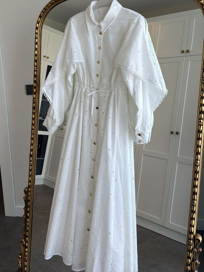 Belted openwork embroidery with gold buttons