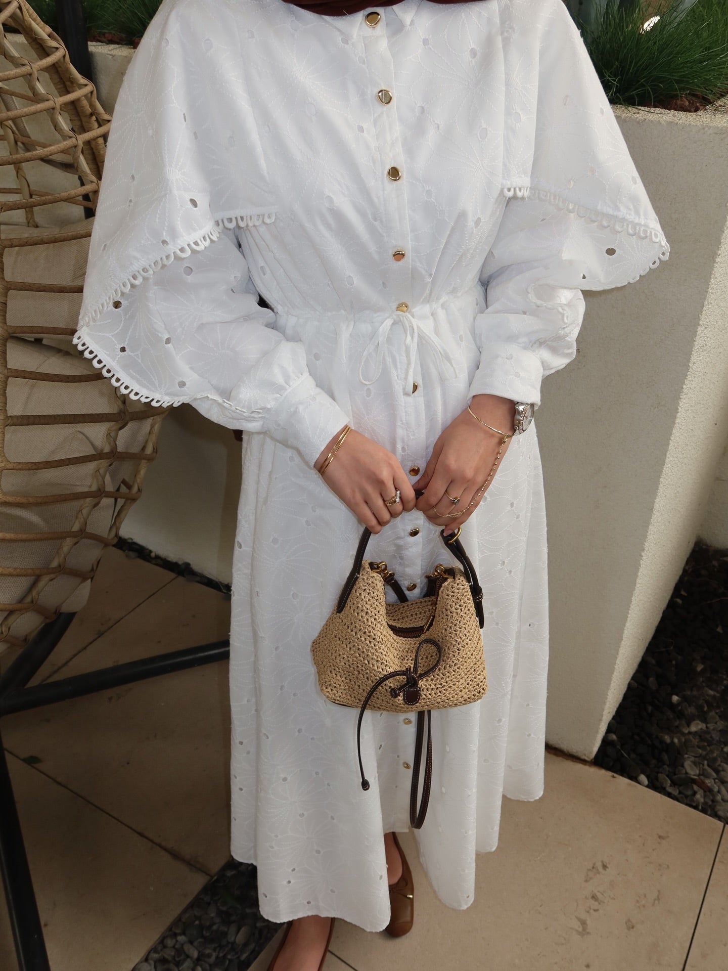 Belted openwork embroidery with gold buttons
