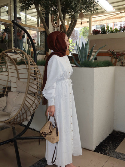 Belted openwork embroidery with gold buttons