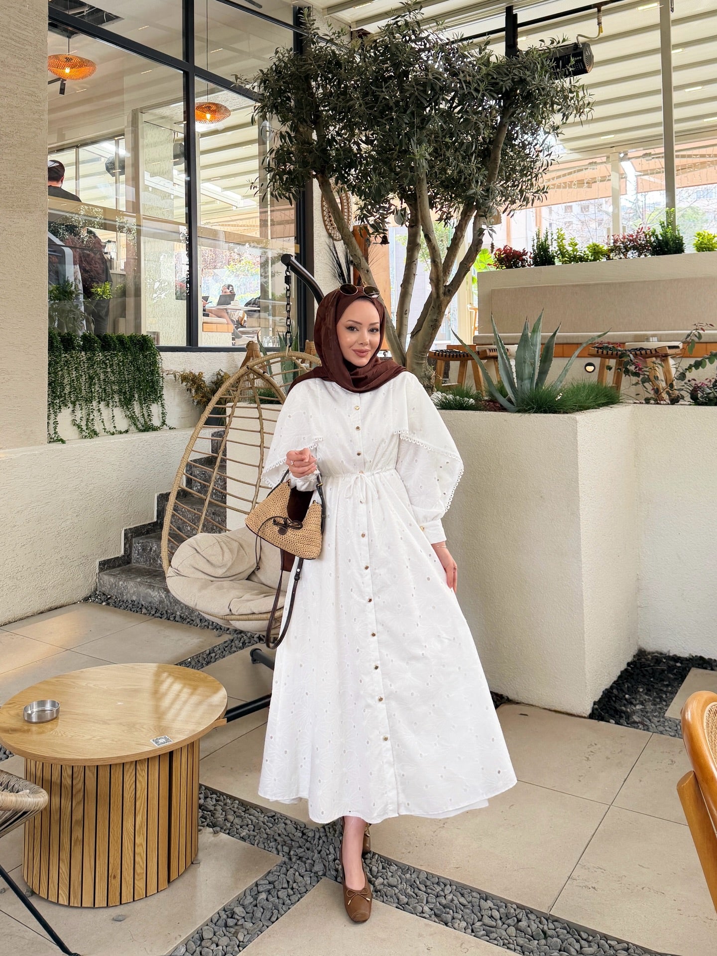 Belted openwork embroidery with gold buttons