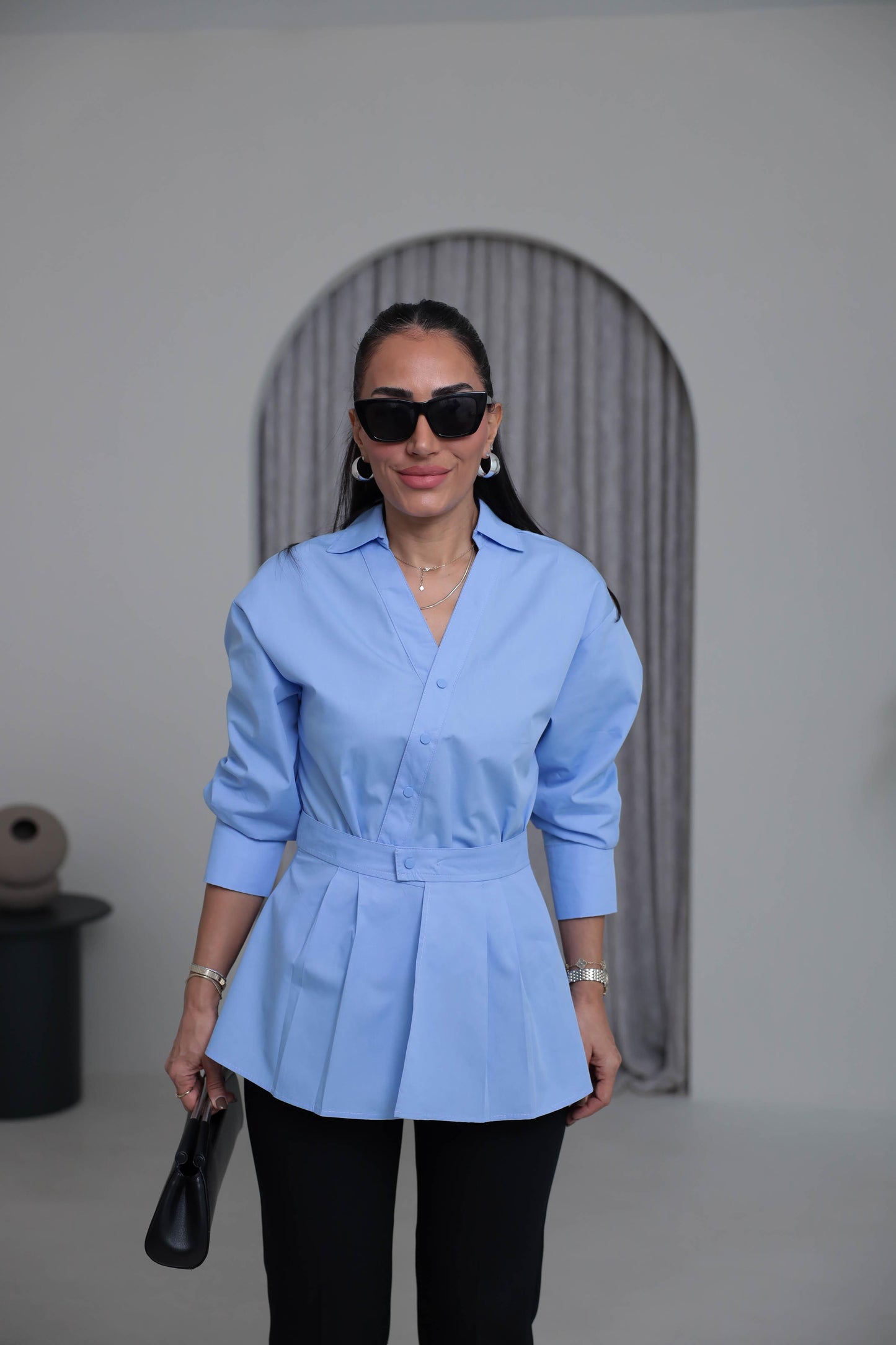 Two-piece shirt (wrappable like a skirt) in blue poplin fabric with an elegant design