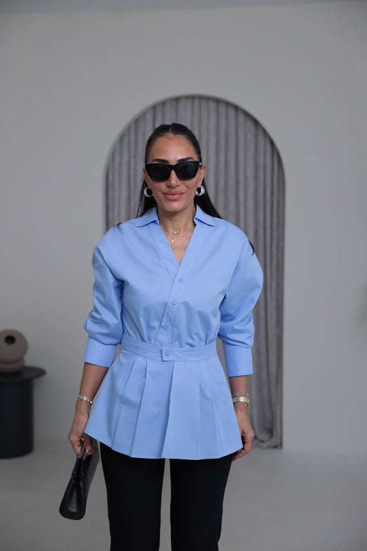 Two-piece shirt (wrappable like a skirt) in blue poplin fabric with an elegant design