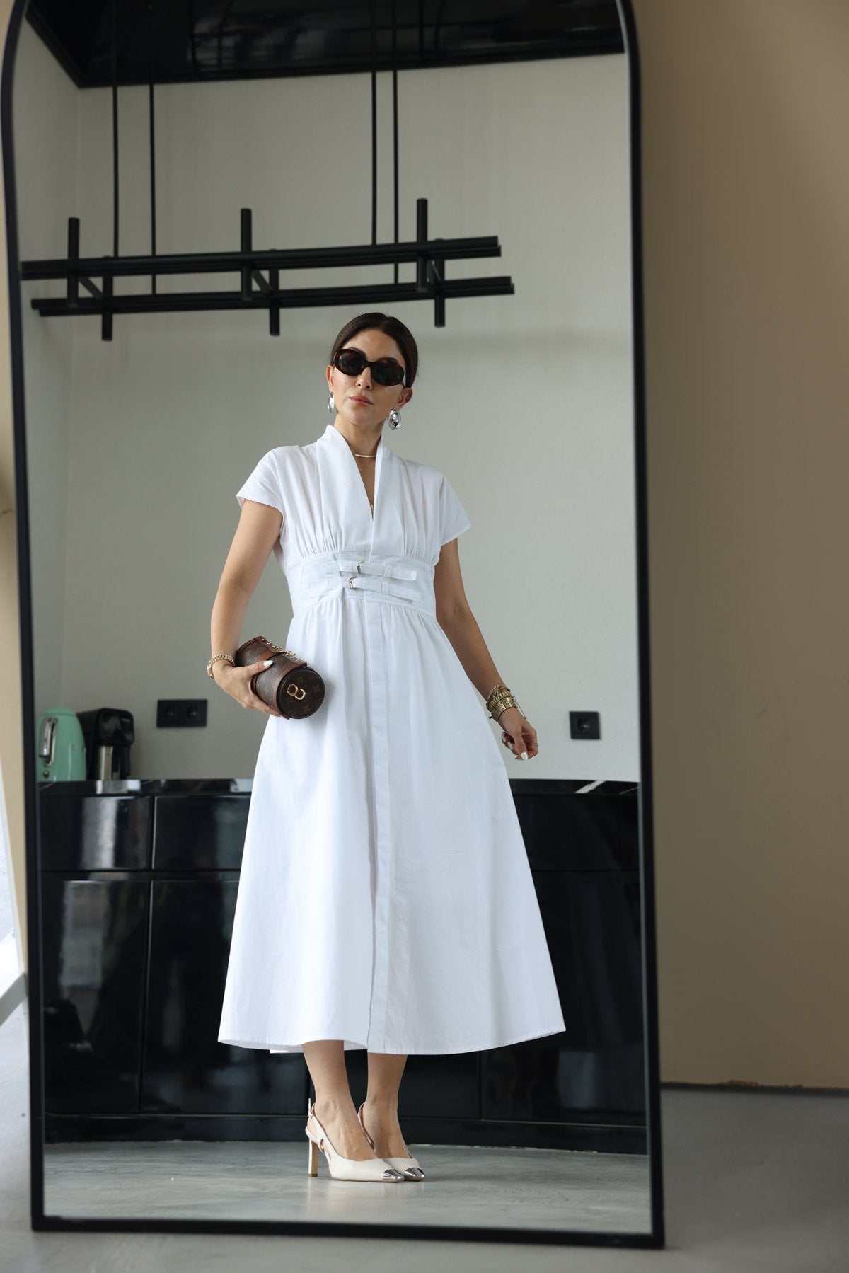 White half-sleeved dress with two belts on the chest