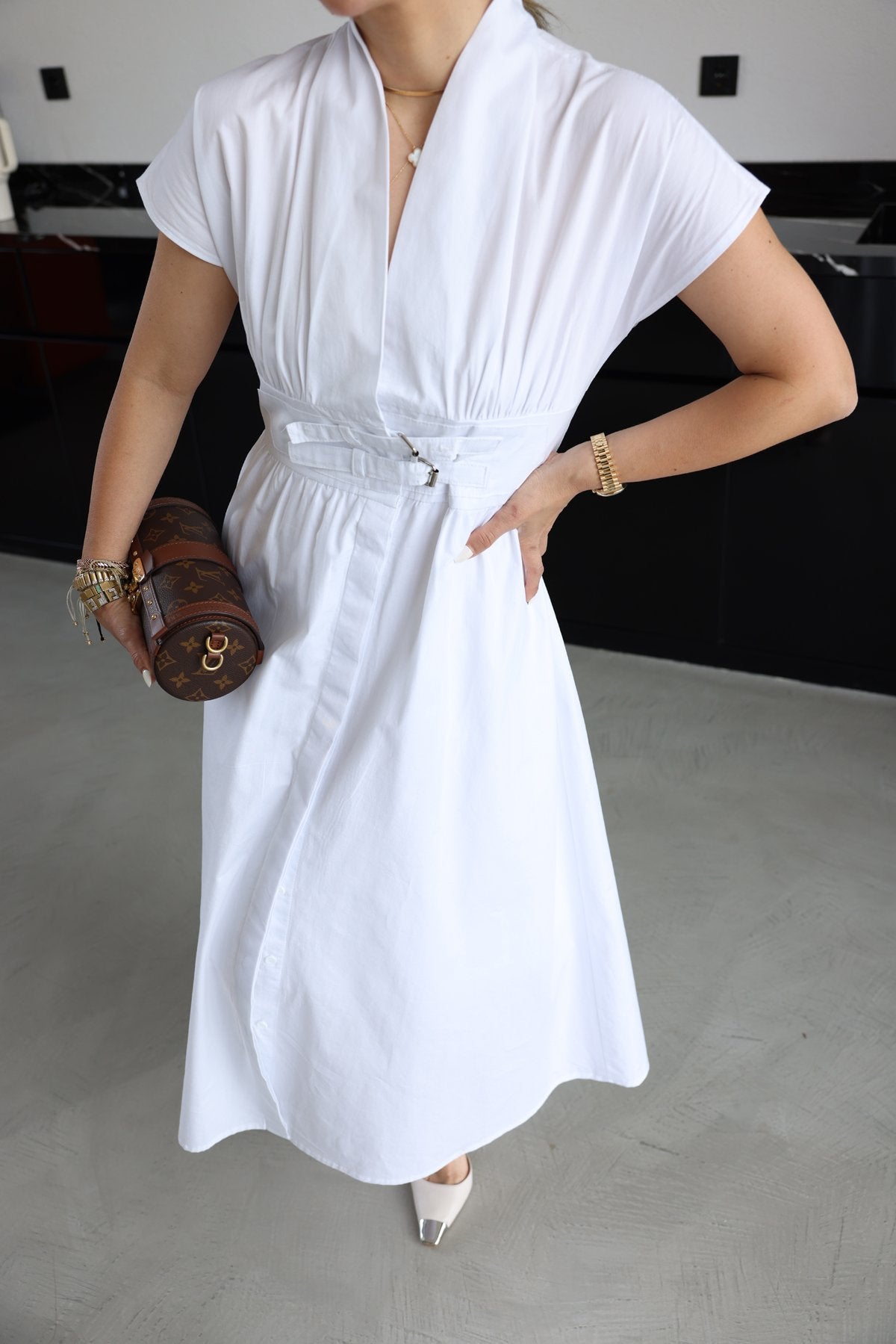 White half-sleeved dress with two belts on the chest